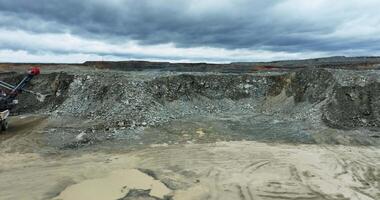 Mining excavator loading ore into a dump truck in open pit mine. Stock clip video