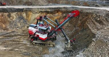 Excavator loading rocks in mining area. Stock clip video