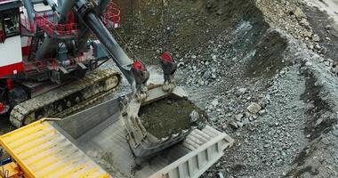 Excavator loading dump truck in quarry, mining operation. Stock clip video