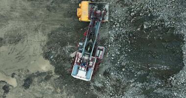 Heavy machinery processes rocks in open pit mining. Stock clip video