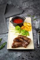 lamb tongues with mashed potatoes and tomato sauce side view photo
