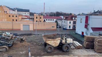 This is a detailed view showcasing a bustling construction site that features heavy machinery and surrounding buildings photo