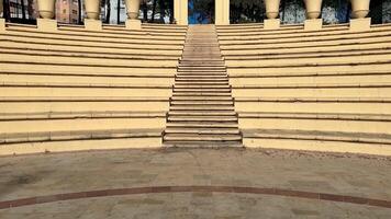 An incredibly beautiful amphitheater featuring welldefined steps, decorative artistic columns, and more photo