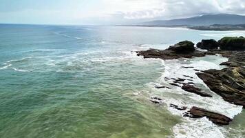 A stunning view of towering cliffs by the ocean, highlighting natures beauty and gentle waves lapping the shore photo