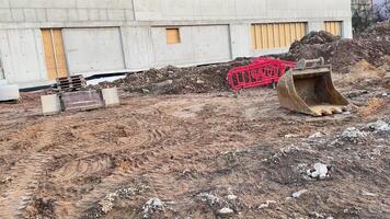 A construction site displaying various earthmoving machinery and a rough, unfinished piece of terrain photo