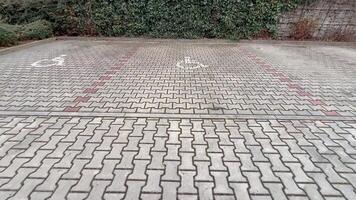 The paved parking area is designed with clear symbols indicating accessibility features and designated spaces photo