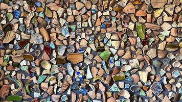 A vibrant display of broken pottery shards, showcasing colors and textures in an artistic arrangement. photo