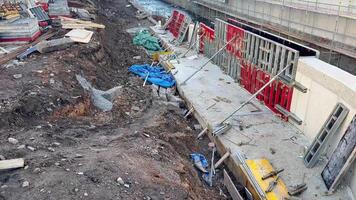 The scene depicts a construction site with various tools and materials actively being used as work continues photo