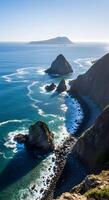 Rocky Coastal Cliffs and Pebble Beach with Turquoise Sea Under Clear Sky photo