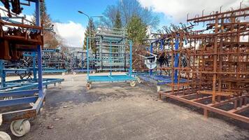This is a detailed view of a storage area showcasing metal racks and equipment in a variety of conditions photo