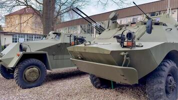Two distinct military armored vehicles in green display their weaponry, signifying readiness for action photo