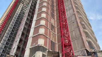 A stunning view of a modern high-rise building under construction, showcasing structural design and cranes. photo