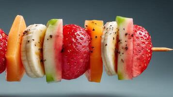 Colorful Fruit Skewer with Watermelon Strawberry Banana and Peach photo