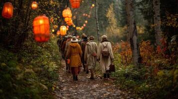 People Walking on Autumn Forest Path with Illuminated Lanterns photo