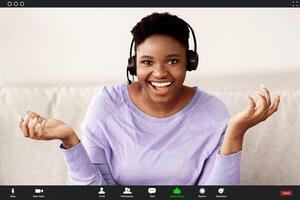Remote Work And Technology. Black Woman Wearing Headset Having Conference, Talking To Camera During Virtual Web Call. Videocall Interface, App Display, Videotelephony And Telecommuting photo