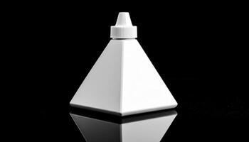 White Triangular Paint Bottle On Reflective Black Surface photo