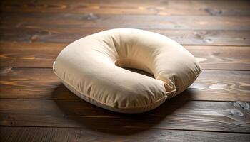 Plain Beige Nursing Pillow On Wooden Table Fabric Texture Detail photo