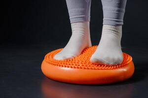 Child Standing on Spiky Balance Cushion for Foot Therapy, Coordination Training, and Sensory Stimulation photo