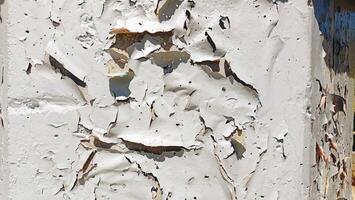 Detailed CloseUp of Peeling White Paint on a Wall Capturing the Unique Texture and Aesthetic photo