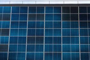 Solar Panels on Building Facade Showing Clean Energy Grid Pattern photo