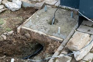 Preparing Concrete Foundation for a Structure with Embedded Cables and Anchor Bolts photo
