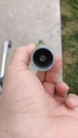 A Detailed CloseUp of a Pipe Opening Captured with the Help of a Hand for Analysis photo