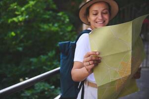 Woman Enjoying Exploration of a Scenic City While Using a Map to Navigate photo