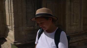 Happy Woman Tourist Explores an Old Medieval City with a Map, Delighting in the Discovery of Historic Landmarks and Beautiful Architecture During Her Solo Travel Adventure. photo