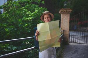 Woman Navigating a Scenic Path with a Map on a Historical Adventure photo