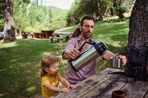 Father and Daughter Enjoying a Relaxing Moment Outdoors in a Scenic Park Area photo