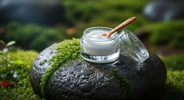 A jar of cream on a rock with moss and a wooden spoon photo