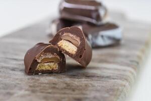 Decadent Chocolate Caramel Shortbread Bites gooey caramel layer atop a crumbly biscuit base on grey slate closeup side view of delightful dessert photo