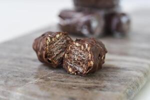 Chocolate Wafer Clusters on Marble, one broken open to reveal the crisp, closeup side view of sweet snack photo