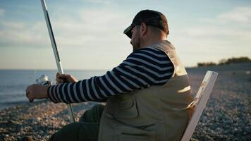Man Fishing On The Shore With The Horizon As Backgorund video
