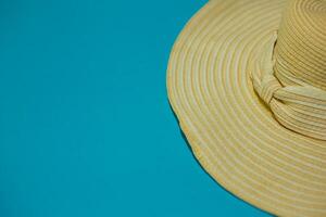 Hat with bow on a blue background. Summer concept. Background for layouts and advertising. photo