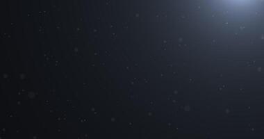 Slowly falling, swirling, and sparkling bokeh particles in white light against a dark background. Abstract snow.221 video