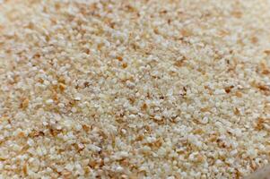 select corn bran, still as good and as select as it is now. macro shot of finely ground cereal, spherhu view. cereal background photo