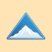 Stylized Snowy Mountain Peak within a Blue Triangle Badge vector
