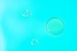Abstract Bubbles Floating on Vibrant Turquoise Background photo