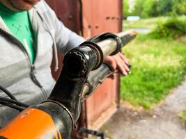 Mechanic fixing broken bicycle stem in workshop photo