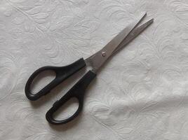 scissors on white office table photo