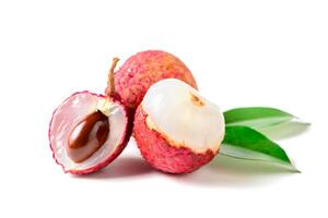 Three Juicy Lychee with cut in half and leaves isolated on white photo