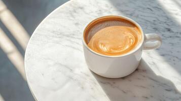 Cup of coffee on white marble table in sunlight with smooth crema and gentle shadows creating a warm and relaxing morning atmosphere. photo