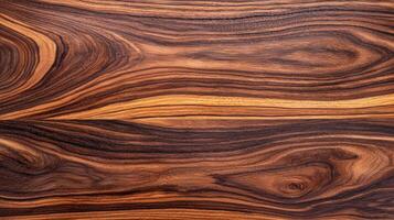Polished exotic wood surface featuring rich swirl grain patterns, warm brown hues, and fine texture suitable for design, furniture, or decorative applications. photo