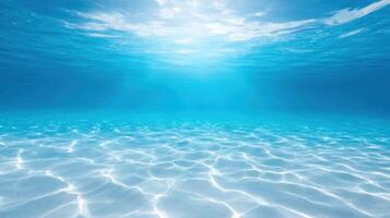 Sunlit underwater ocean view with sandy seabed and rippling water in a bright, tropical and serene aquatic setting. photo