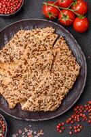 Crispbread, thin bread with seeds and grains, a baked cracker. photo