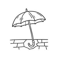 A folded umbrella resting over a broken piece of sidewalk tile vector