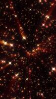 Dynamic explosion of glowing red and yellow particles in space, creating a starburst effect against a dark background video