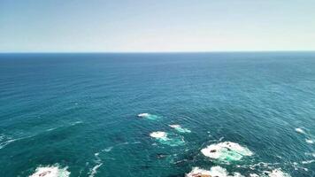 Experience stunning aerial views of a vast water body framed by rocky shores. This captures boats navigating the serene surface, highlighting nature and recreation video