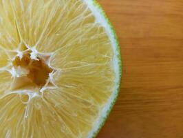 Fresh Lime Close-Up Detail. A close-up image of a juicy lime slice showing its translucent segments and vibrant green rind. photo